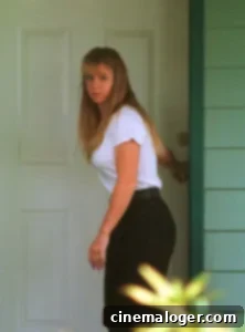 Margot Robbie's Shocking Tonya Harding Transformation: 20 Pounds and Frizzy Hair 2 Margot Robbie as Tonya Harding with frizzy hair and a drab sweater on set