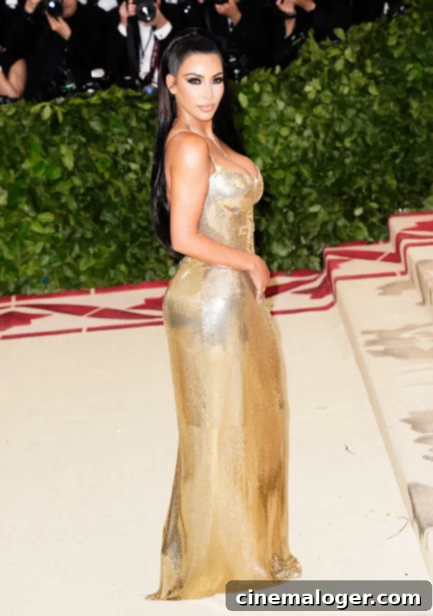 Kim Kardashian's 40 Years of Style: Her Most Showstopping Looks 2 Kim Kardashian in a shimmering gold Versace gown at the 2018 Met Gala
