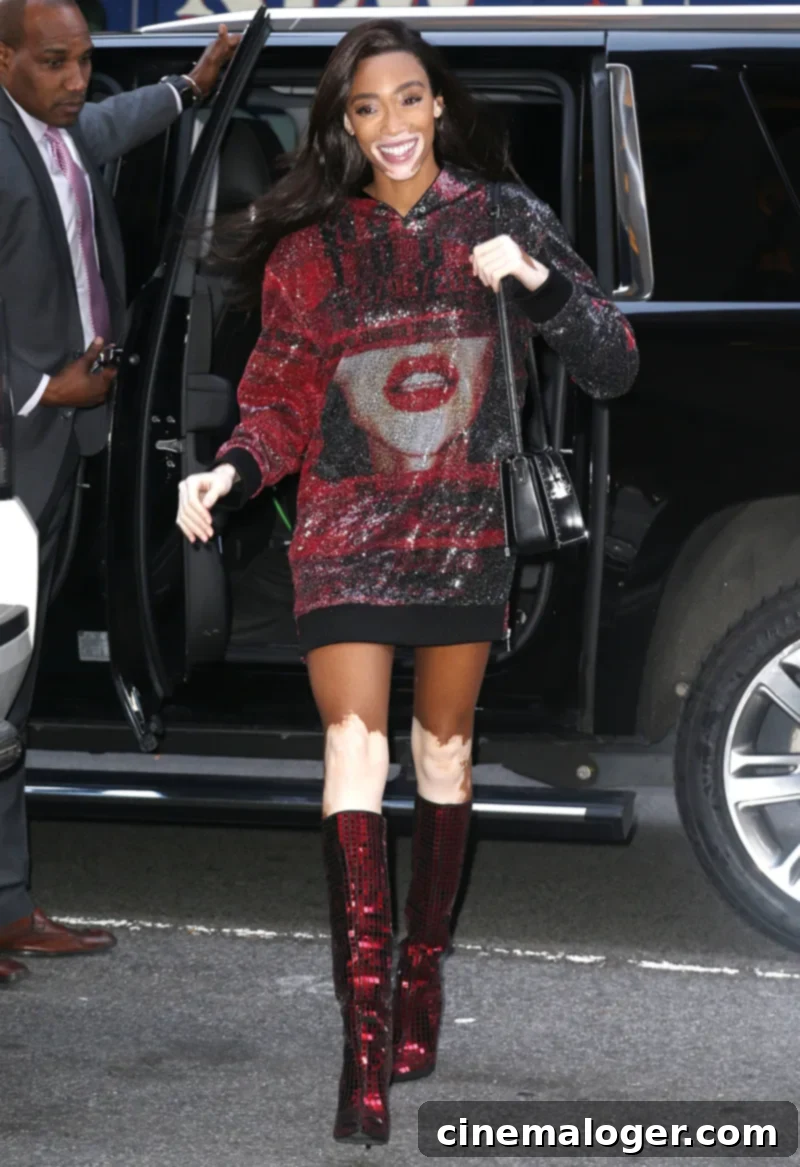 Michelle Obama, Taylor Swift, Winnie Harlow, and Four Other Stars Rock Sparkly Sequin Boots 2 Winnie Harlow in ruby red sequin boots and Balmain hoodie.