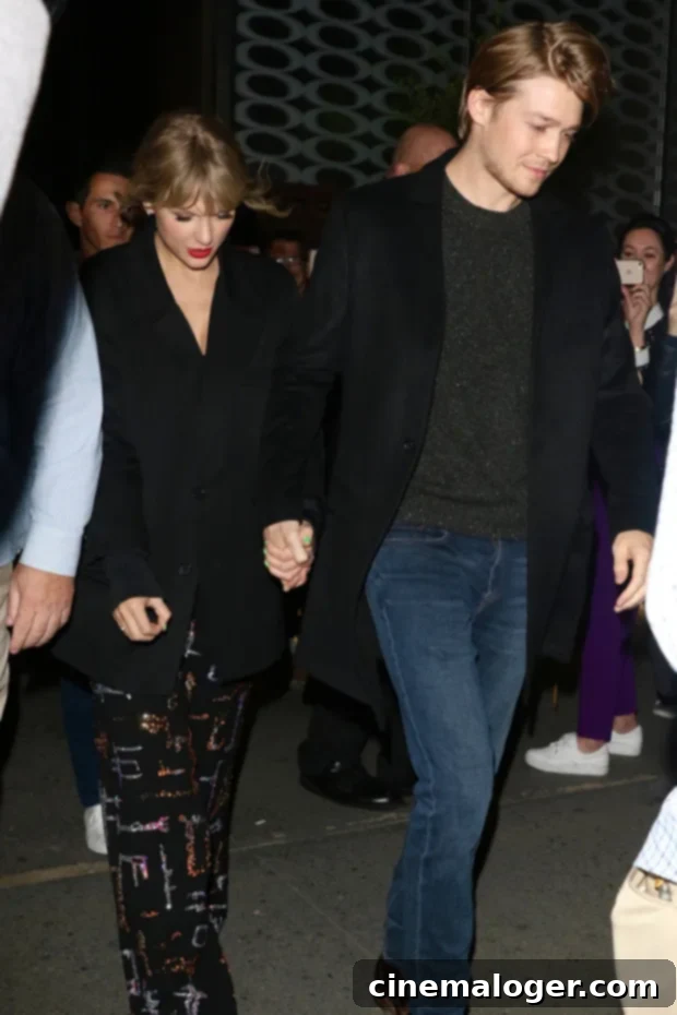 Joe Alwyn Turns 30 12 Sweet Public Photos With Taylor Swift 3 Joe Alwyn guiding Taylor Swift into a car after a private event.