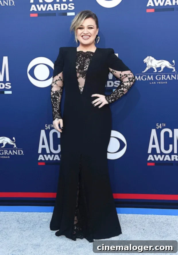 Kelly Clarkson Stuns in Black Lace on ACMs Red Carpet 2 Kelly Clarkson stuns in a chic black dress on the ACM Awards red carpet, showcasing her style and excitement.