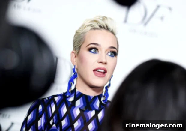 Eye-Catching Coordination: Stars' Eyeshadow and Vibrant Dress Pairings 3 Katy Perry in a blue geometric dress with blue eyeliner.