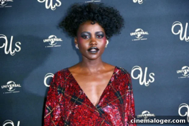Eye-Catching Coordination: Stars' Eyeshadow and Vibrant Dress Pairings 4 Lupita Nyong'o in a red dress with red eye makeup.