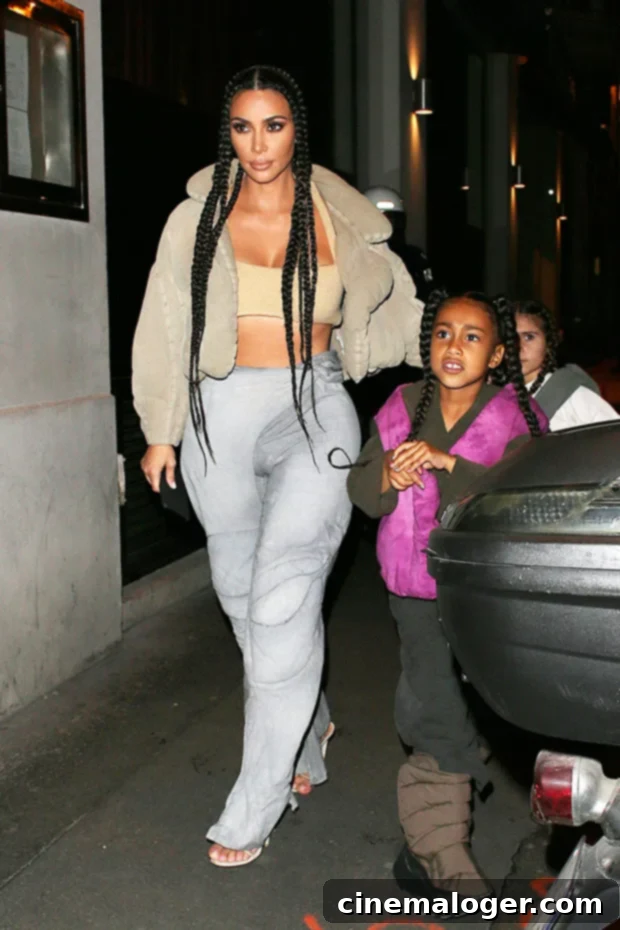 Yeezy's Reign: Kim Kardashian's 16 Hottest Looks for Kanye's Birthday 3 North West on stage with Kanye, dressed stylishly, reflecting the family's deep involvement in the Yeezy brand.