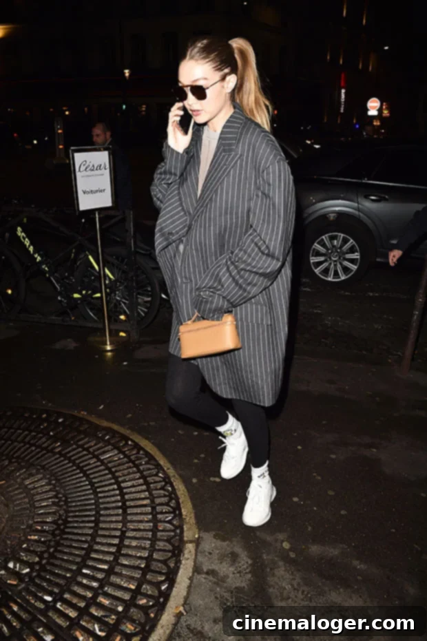 Gigi Hadid, Kendall Jenner And 18 Stars Show How Easy High Ponytails Can Be 2 Gigi Hadid in a high ponytail, oversized sweater, and pinstripe coat