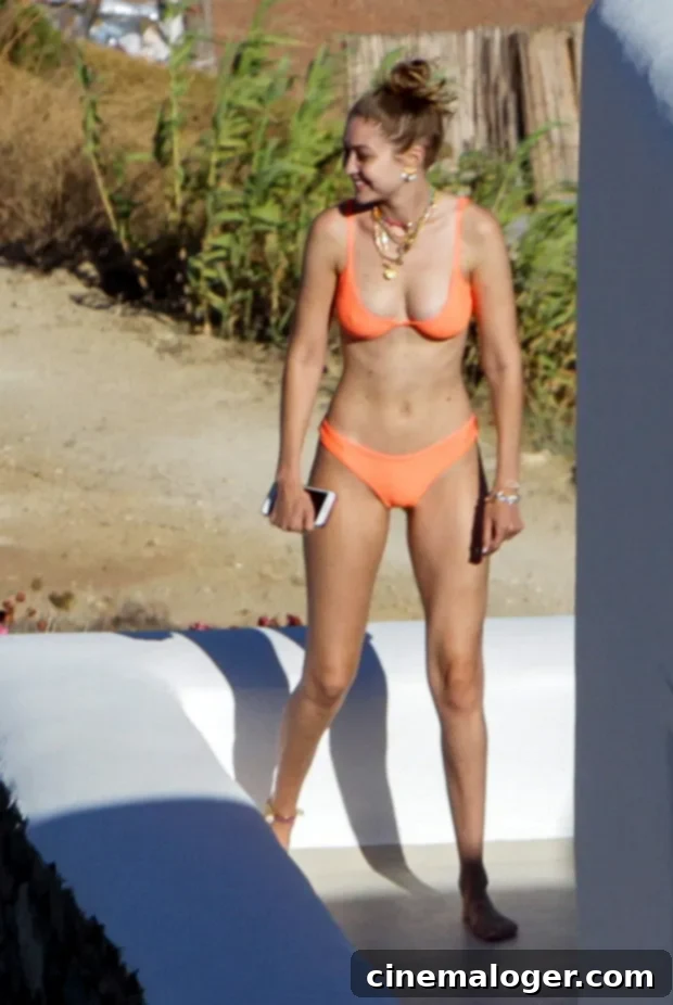 Gigi Hadid's Stunning Orange Bikini and Endless Legs Heat Up Her Greece Getaway 3 Gigi Hadid shows off her long legs in an orange bikini