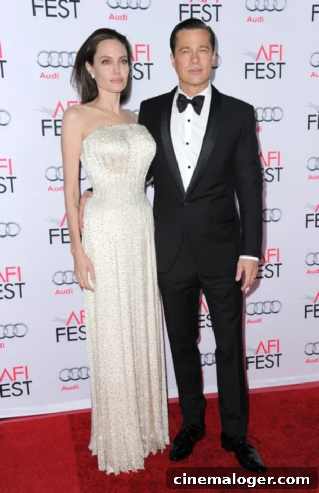 Brad Pitt on a red carpet looking thoughtful.