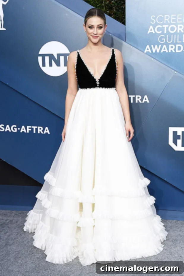 Lili Reinhart dazzles in a black and white gown at the SAG Awards red carpet.