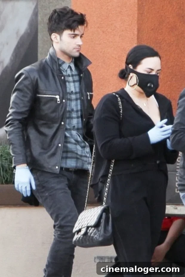 Demi Lovato's Birthday Beach Bliss: Passionate Kiss with Max Ehrich 2 Demi Lovato and Max Ehrich, a celebrity couple in a loving relationship