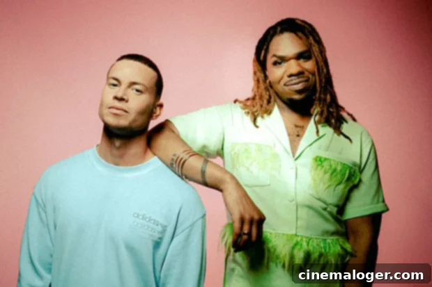 Joel Corry & MNEK Drop Feel-Good Anthem Head & Heart 3 MNEK, a talented singer-songwriter and producer, posing for a photo.