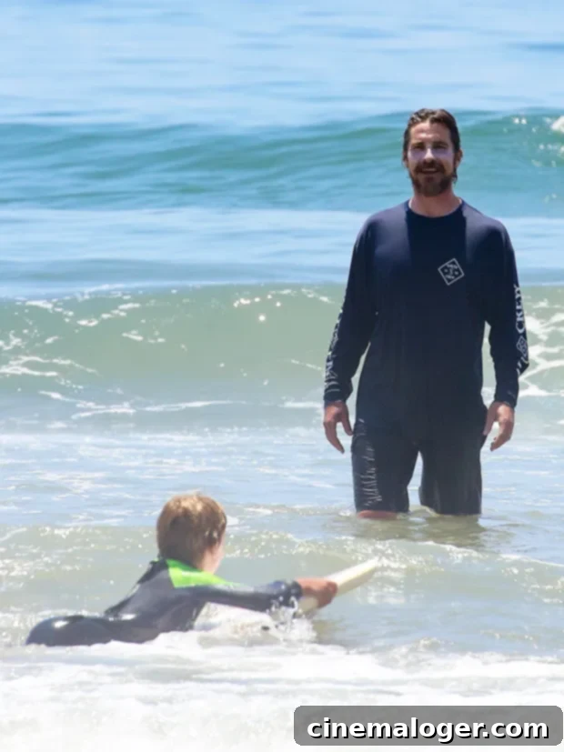 Christian Bale, Jennifer Garner & Celebs Bond With Kids Body-Boarding At The Beach 2 Christian Bale watching his son bodyboarding in Malibu