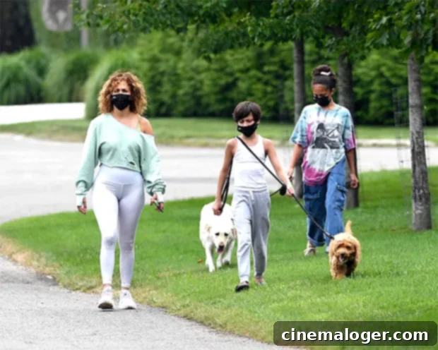 Jennifer Lopez Rocks Natural Curls on Morning Walk With Her 12-Year-Old Twins Max and Emme 2 Jennifer Lopez with her twins Max and Emme, taking a morning walk with her dogs in The Hamptons.