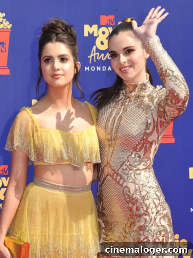 Laura and Vanessa Marano Spotlight Survivor Stories on Anti-Trafficking Day 2 Vanessa and Laura Marano stand together, smiling slightly. Vanessa, on the left, wears a striped shirt. Laura, on the right, wears a white top with a pattern. They both have long, dark hair.