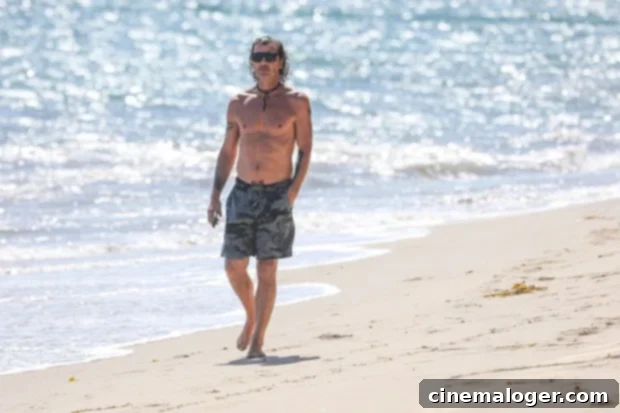 Gavin Rossdale, 54, Defies Age Shirtless On The Beach – Plus 23 More Over-45 Stars With Jaw-Dropping Summer Bodies 2 Gavin Rossdale enjoying a solo beach walk, showcasing his impressive physique.