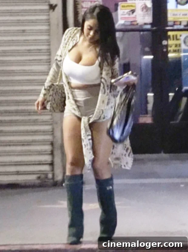 Rob Kardashian's Gorgeous Date Aileen Gisselle Makes First Public Appearance 2 Aileen Gisselle seen in a stylish casual outfit, carrying a handbag and phone, following her dinner date with Rob Kardashian.