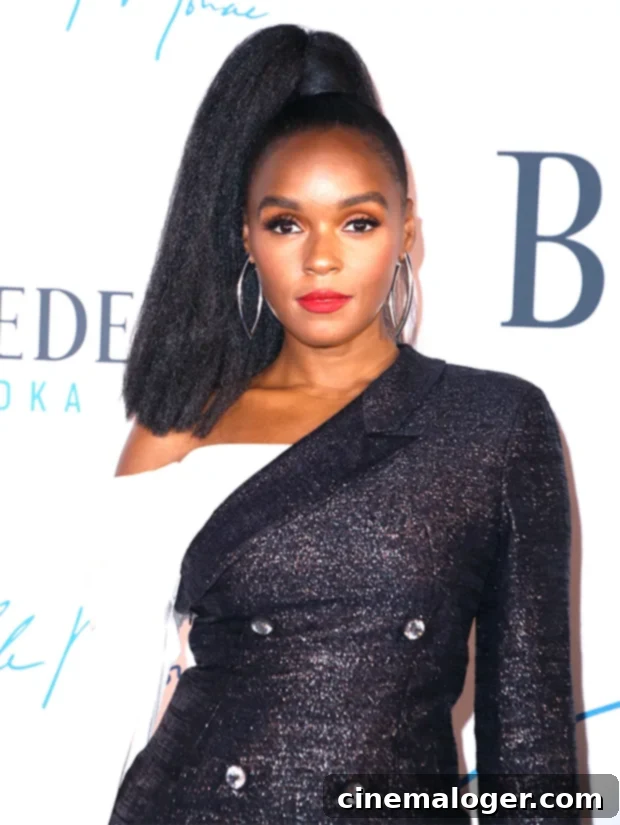 Janelle Monae with long, dark hair before her orange hair makeover