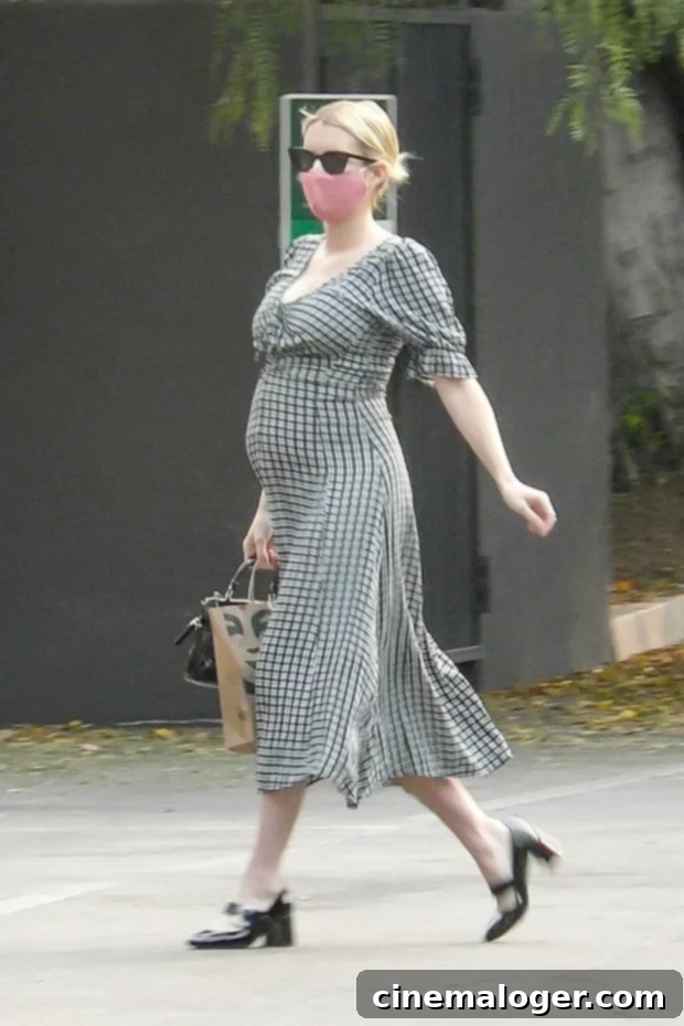 Isolation Chic: Kourtney, J.Lo & The Week's Top Celebrity Looks 4 Emma Roberts in a black and white checkered midi dress