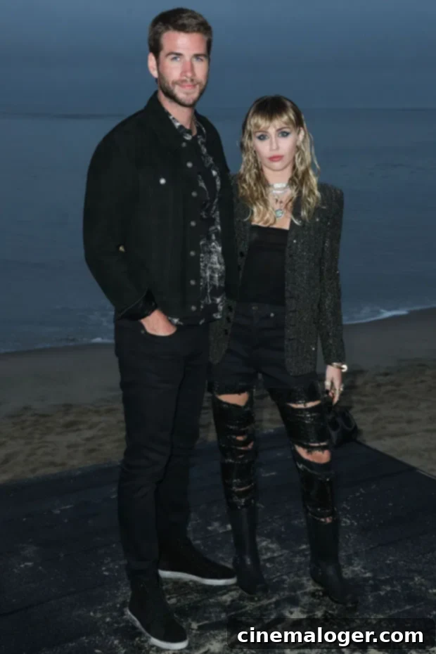 Miley Cyrus Shades Ex Liam Hemsworth On 'Win Some, Lose Some' Over 'Faking It' Lyric 2 Liam Hemsworth, Miley Cyrus walking hand-in-hand