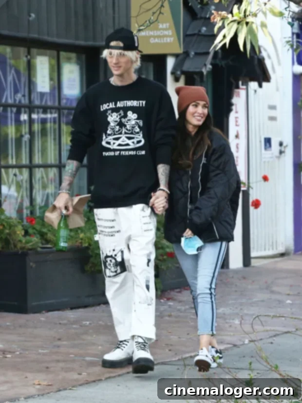Megan Fox Dubs Machine Gun Kelly Romance 'Once In A Lifetime,' Eclipsing Brian Austin Green 2 Megan Fox and Machine Gun Kelly holding hands, symbolizing their intense romance