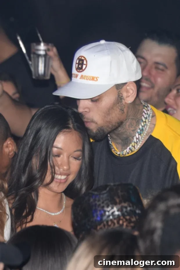 Chris Brown and Ammika Harris pose together at a club in Paris during Fashion Week.
