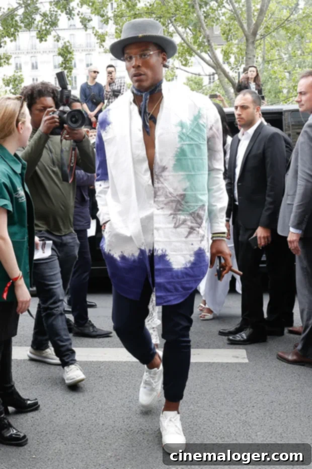 Cam Newton'dan Tarz Evrimi İtirafı: 2021'de Lüks Modaya Paydos! 3 Cam Newton in a stylish patterned suit and hat at Paris Fashion Week.