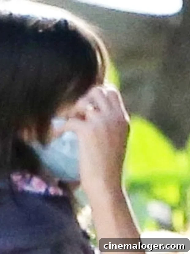 Eva Mendes's Gold Band Sparks Marriage Buzz During Rare Family Hike With Ryan Gosling 3 Eva Mendes adjusts her daughter's mask during a hike with her family in Los Feliz on January 27, 2021