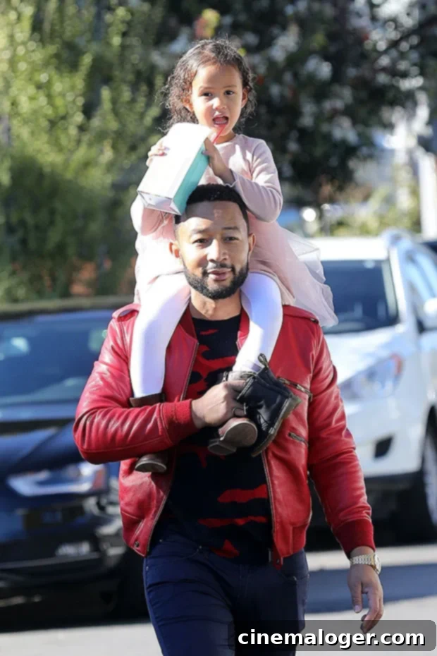 John Legend carrying Luna on his shoulders during a family outing in Beverly Hills