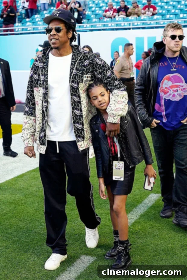 The Blue Ivy Effect: How Her Success United Beyonce and Jay-Z 3 Jay-Z and Blue Ivy Carter on a football field at an NFL game, Jay-Z with arm around Blue Ivy