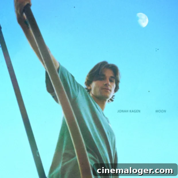 Jonah Kagen stands silhouetted against a bright, hazy background, looking out into the distance. His posture conveys a sense of contemplation.