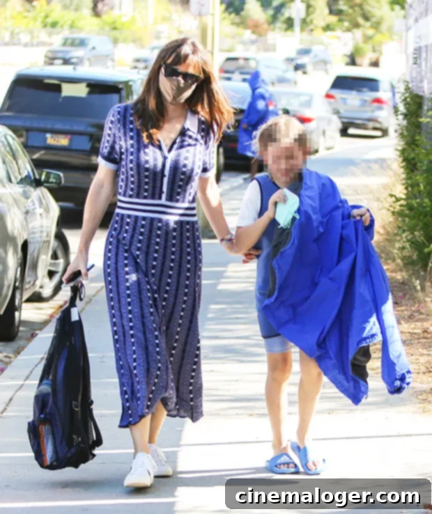 Jennifer Garner: Effortless Maxi Dress Chic for Son Samuel's Swim Practice 2 Jennifer Garner picks up her son Samuel from swim practice, looking stylish in a navy dress.