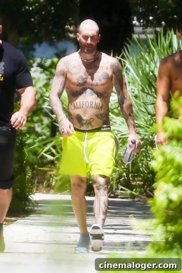 Adam Levine Flaunts Shirtless Physique in Miami Gym, Rocking Bright Neon Shorts 2 Adam Levine rocks bright yellow shorts on his way to the gym in Miami.