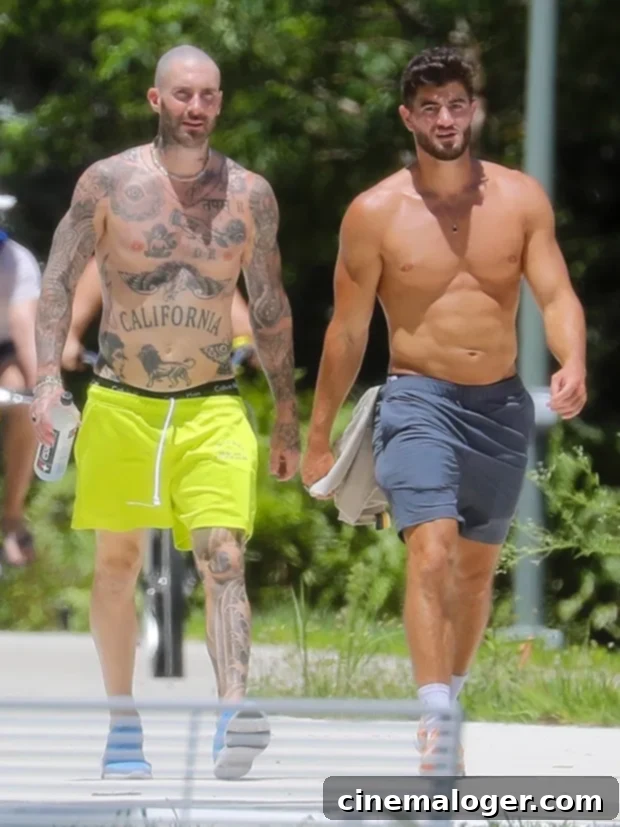 Adam Levine Flaunts Shirtless Physique in Miami Gym, Rocking Bright Neon Shorts 3 Adam Levine and his personal trainer went shirtless on their way to the gym.