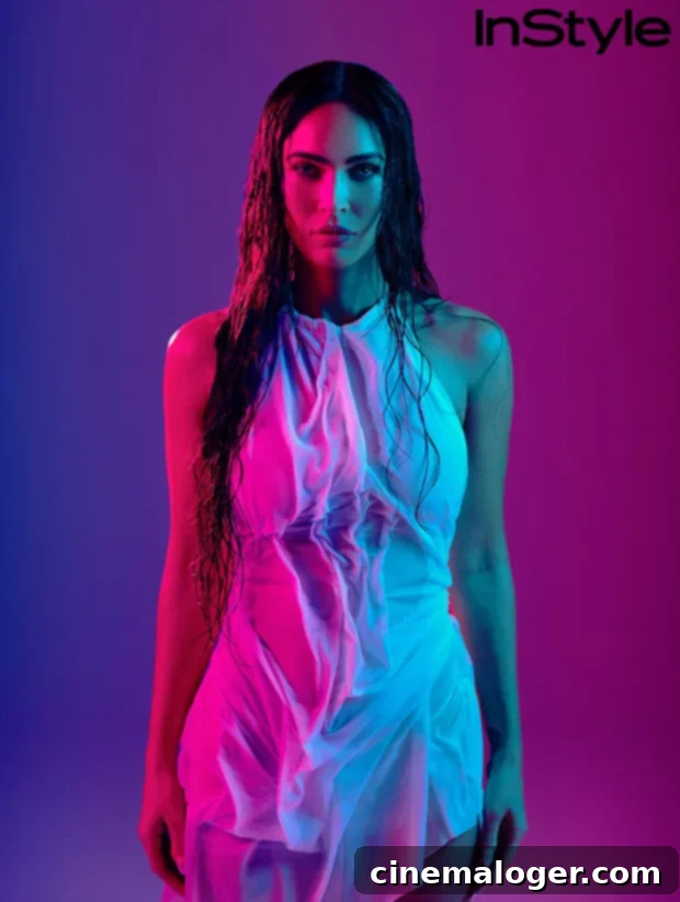 Megan Fox, a prominent actress, stands confidently in a stylish outfit, embodying grace and strength amidst public scrutiny.