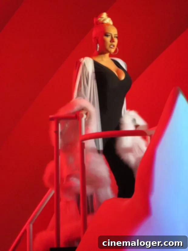 Christina Aguilera Dazzles Hollywood Bowl in Plunging Black 2 Christina Aguilera performing at the Hollywood Bowl in a black jumpsuit and white robe with the LA Philharmonic