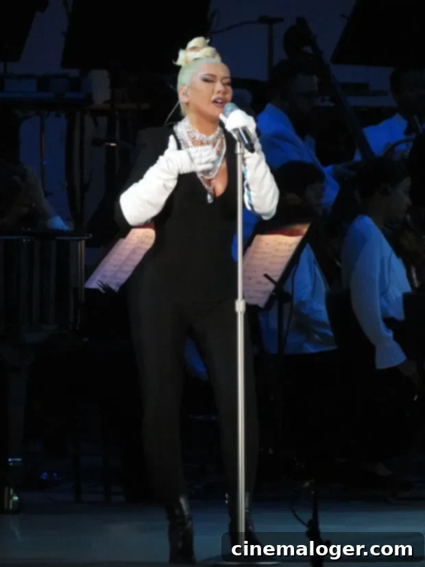 Christina Aguilera Dazzles Hollywood Bowl in Plunging Black 3 Christina Aguilera singing passionately on stage at Hollywood Bowl with Gustavo Dudamel and LA Philharmonic