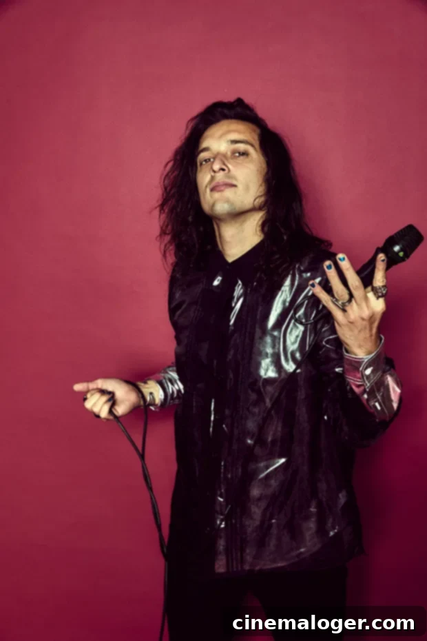 Classless Act Ignites 'Give It To Me,' Vows Rock Will Never Die 3 Derek Day, the charismatic vocalist of Classless Act, captured in a striking solo portrait. He exudes rockstar energy, perhaps mid-performance or in a dramatic pose, reflecting the band's glam rock influences.