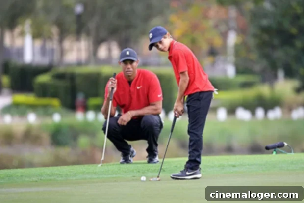 New Series Reveals Tiger Woods' Emotional Reaction To Son Charlie, 12, Playing Golf 2 Tiger Woods and son Charlie playing golf together, Charlie is focused on his shot