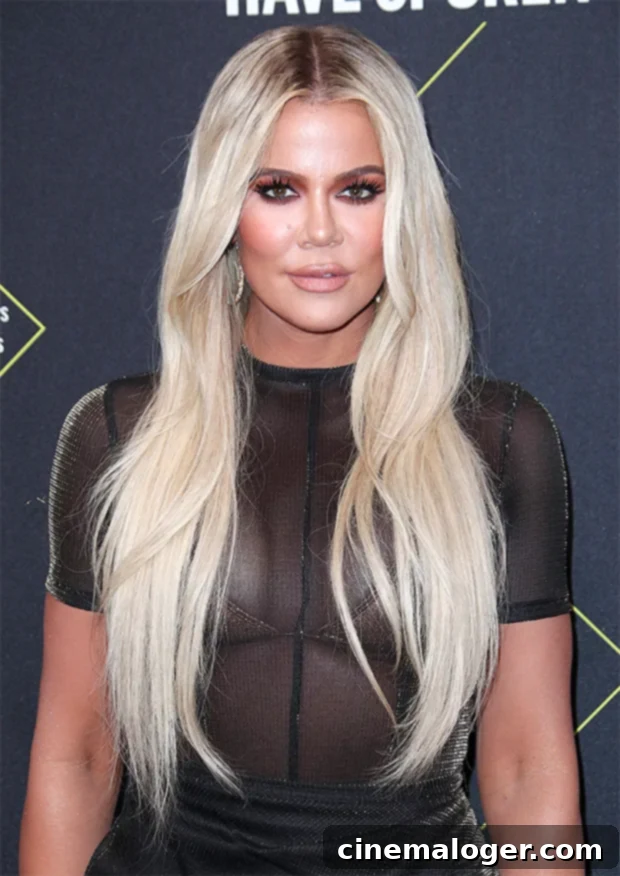 Khloe Kardashian Shows Off Her Natural Hair Looking Cute 2 Khloe Kardashian with long, straight blonde hair, a stark contrast to her recently revealed natural curly bob, demonstrating her versatile style.