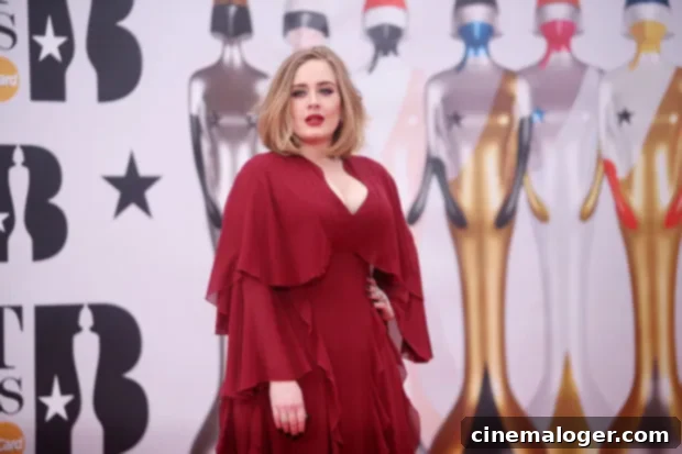 Adele Turns Up The Heat In A Miniskirt For Romantic Date With Rich Paul 2 Adele at a public event, dressed in a black top and a patterned skirt