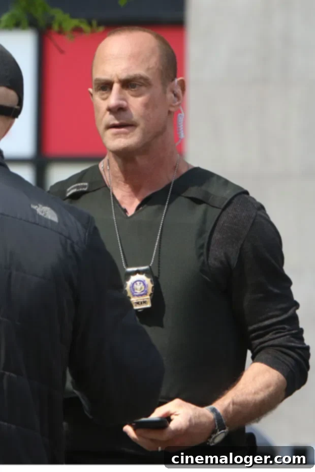 Christopher Meloni Surprises Mariska Hargitay at US Open 3 Christopher Meloni, smiling and engaged, captured during his appearance, highlighting his charismatic presence.