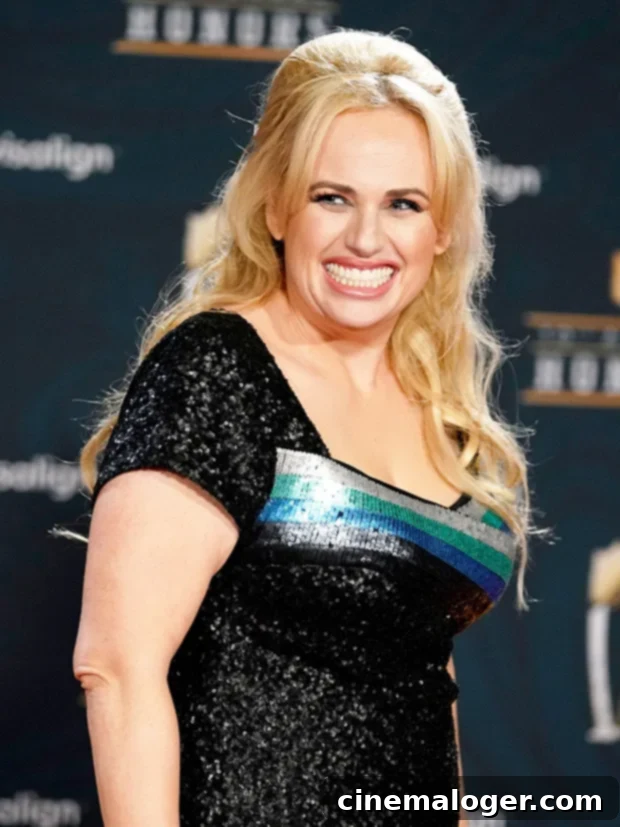 Rebel Wilson Stuns Emerging From The Water In A Low-Cut Black Swimsuit 2 Rebel Wilson enjoying a moment of relaxation and natural beauty.
