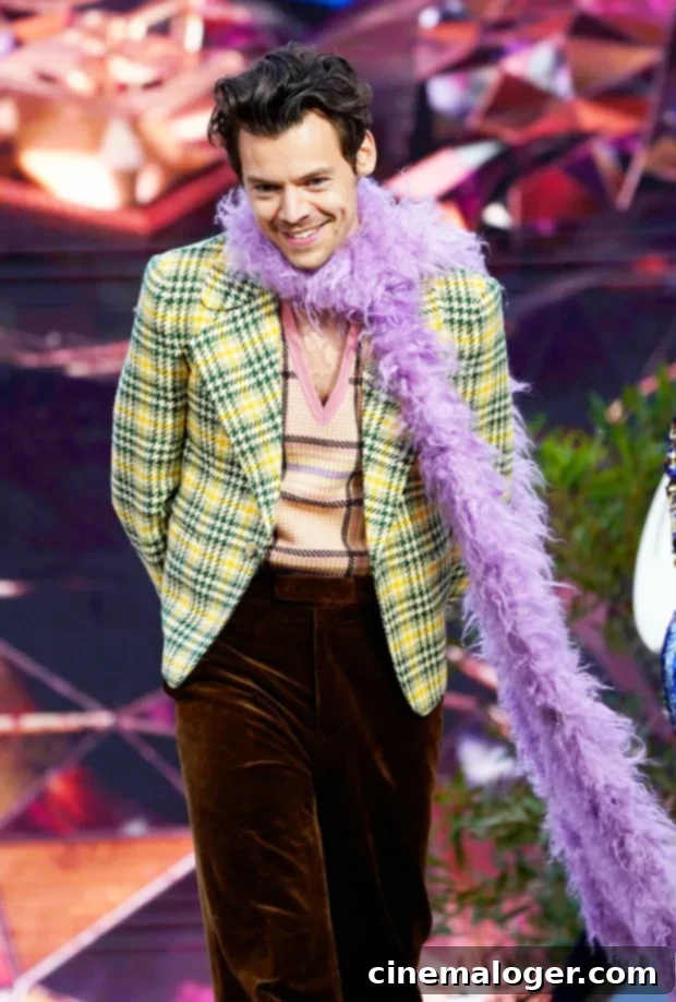 Olivia Wilde Grooves To Harry Styles' Concert Performance 2 Harry Styles performing on stage, illuminated by lights.