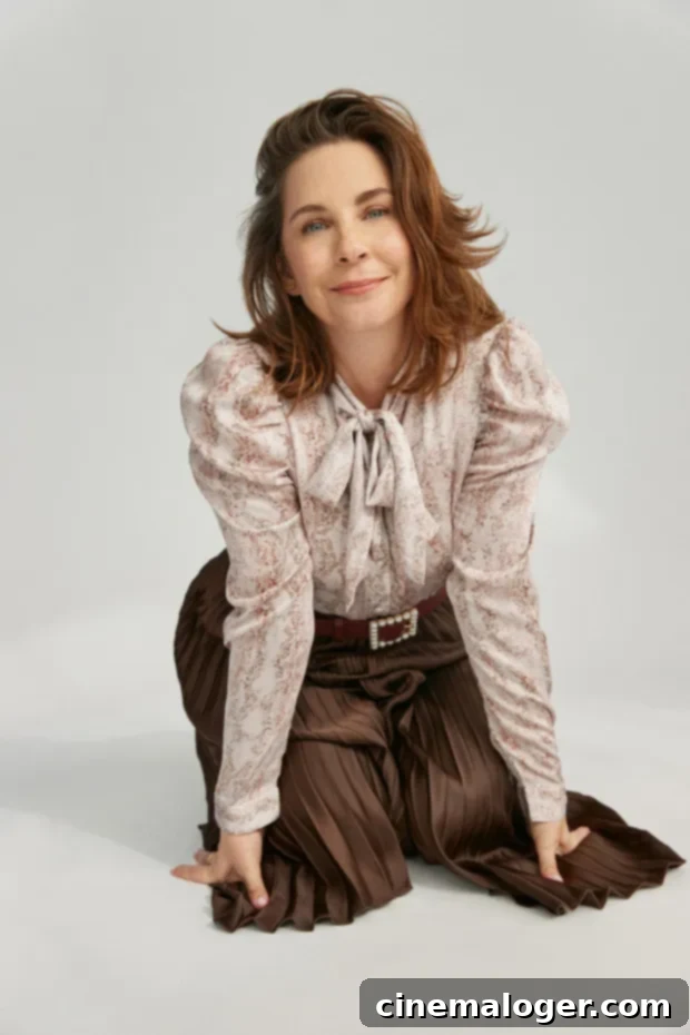 Sweet Magnolias Star Allison Gabriel Feared 'Monster' Mary Vaughn Was Being Written Out 3 Allison Gabriel smiling genuinely, dressed in a chic, light-colored blouse, showcasing her warm personality contrasting her Sweet Magnolias character.
