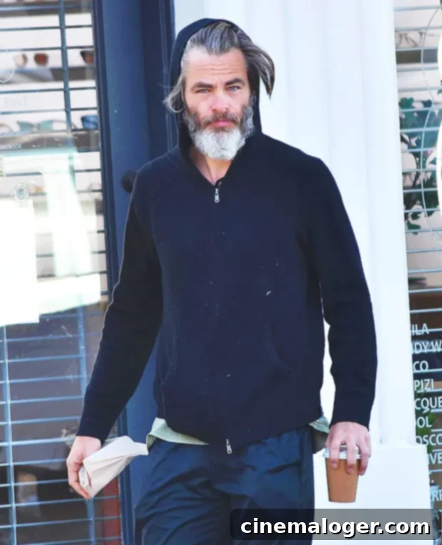 Chris Pine with a long grey beard and long grey hair, looking unrecognizable.