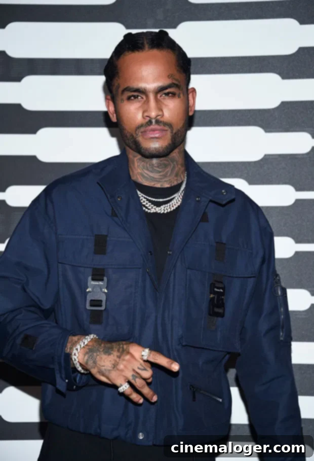 Dave East Cherishes Fortunate Bond With Brother Nipsey Hussle 2 Dave East looking contemplative, wearing a stylish jacket, embodying a serious and thoughtful demeanor.