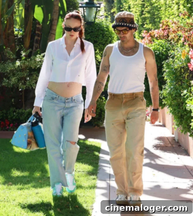 Sophie Turner's Baby Bump Takes Center Stage Twinning With Joe Jonas 2 Sophie Turner shows off her baby bump in a white top with Joe Jonas