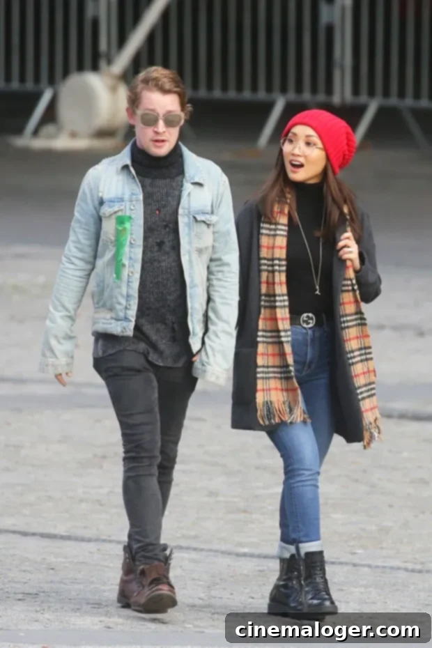Culkin Family Rocks Matching Mohawks: Macaulay, Brenda, and Son Dakota Step Out 2 Macaulay Culkin and Brenda Song walking side-by-side with their son in a stroller.