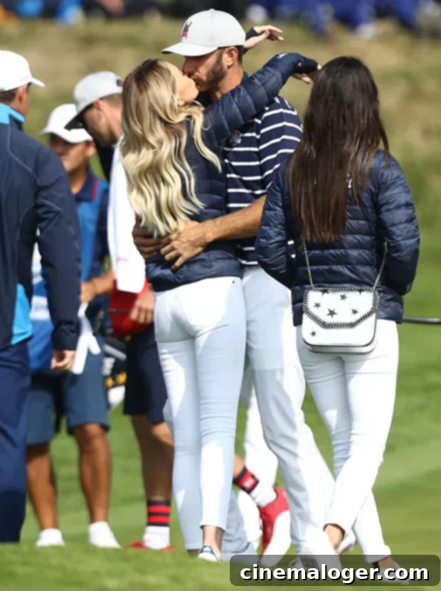 Paulina Gretzky and Dustin Johnson's Journey to Marriage: A Complete Relationship Timeline 4 Dustin Johnson and Paulina Gretzky share a loving kiss after his victory on the 16th hole of the 2018 Ryder Cup, celebrating his achievement.