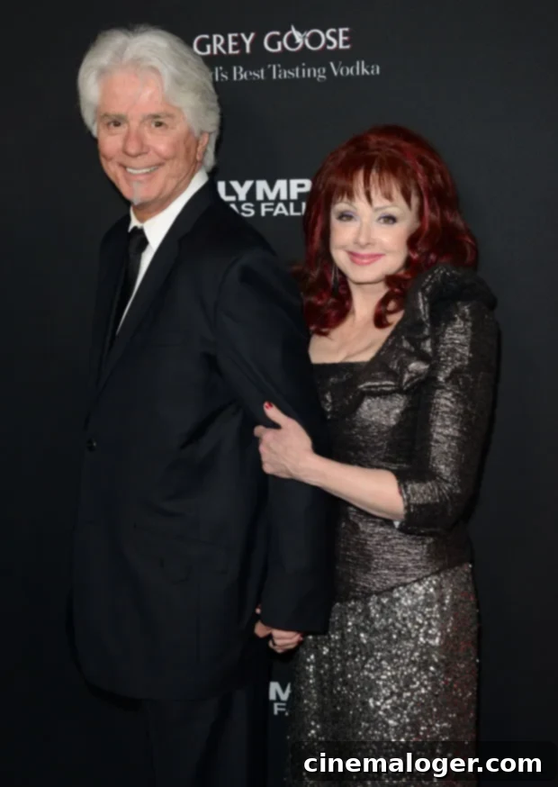 Naomi Judd's Love Life: Larry Strickland and Her First Marriage 2 Naomi Judd and her husband Larry Strickland smiling and embracing at an event.