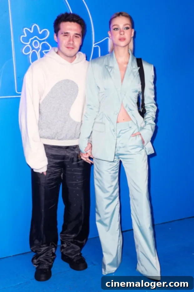 Brooklyn Beckham and Nicola Peltz's Loved-Up Dior Red Carpet PDA 2 Nicola Peltz and Brooklyn Beckham share a sweet moment at Dior's Men's fashion show in Los Angeles, showcasing their newlywed glow and coordinated style.